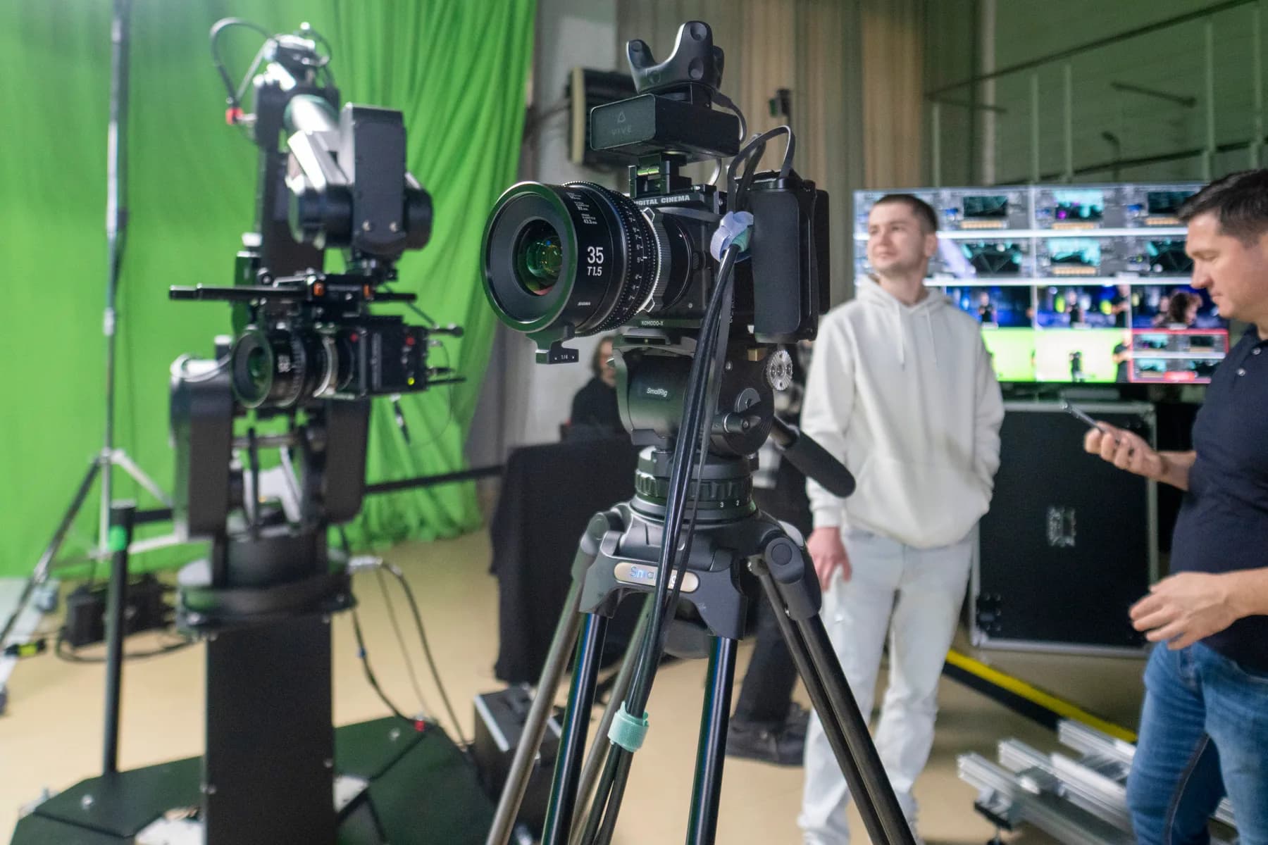 Cinema camera with a prime lens mounted on a robotic arm on the studio floor