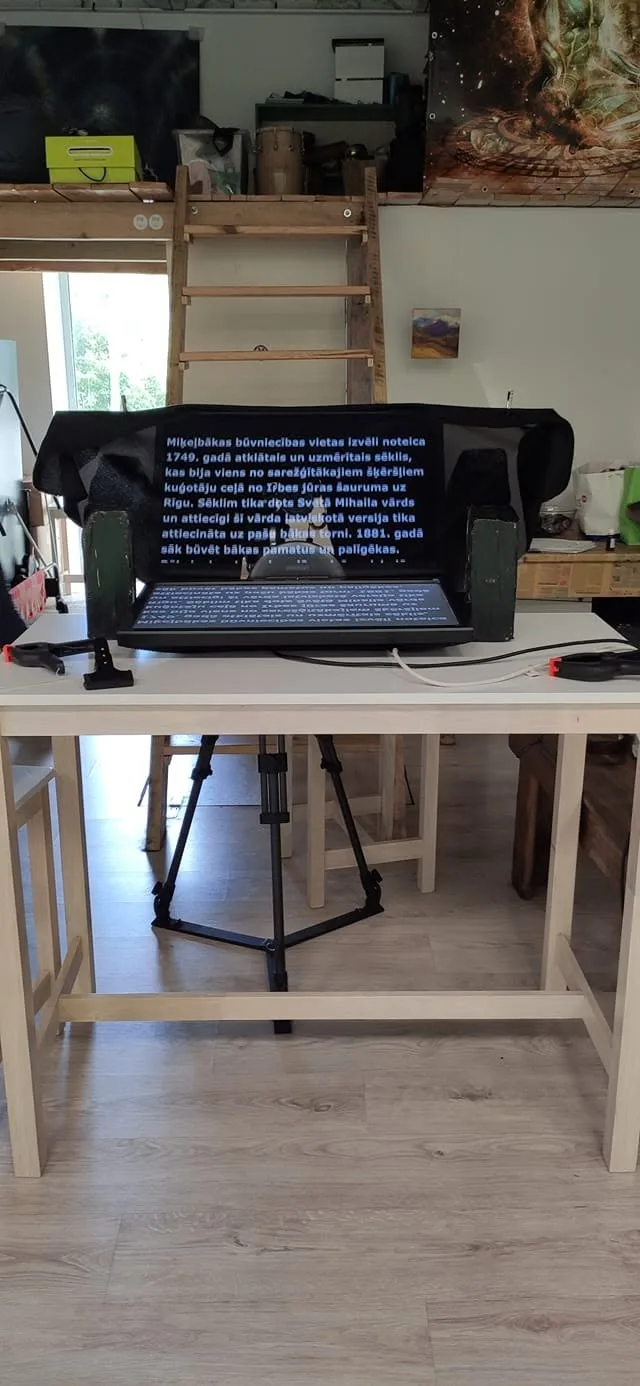 Teleprompter monitor displaying a script on a tripod rig